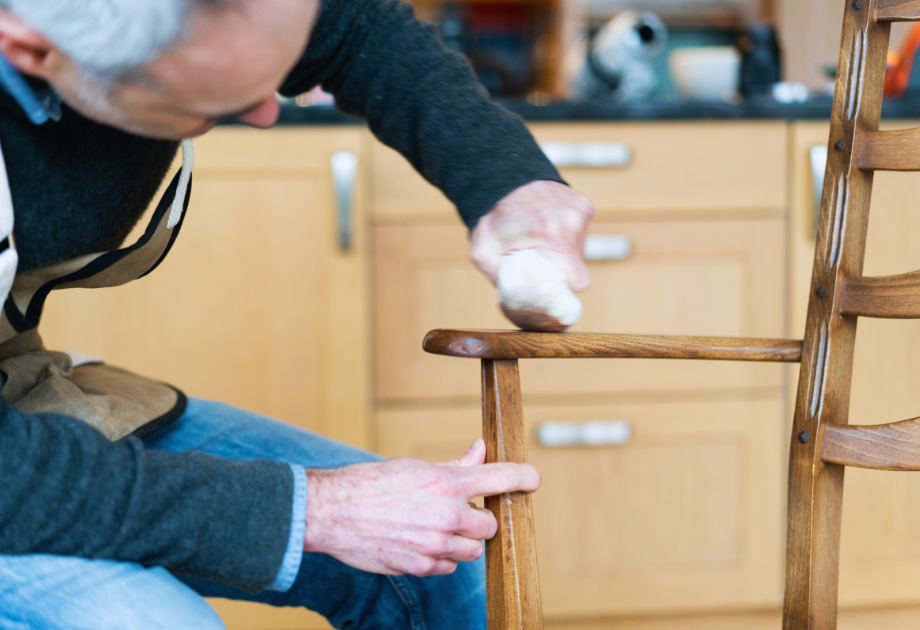 Man oiling a chair. 